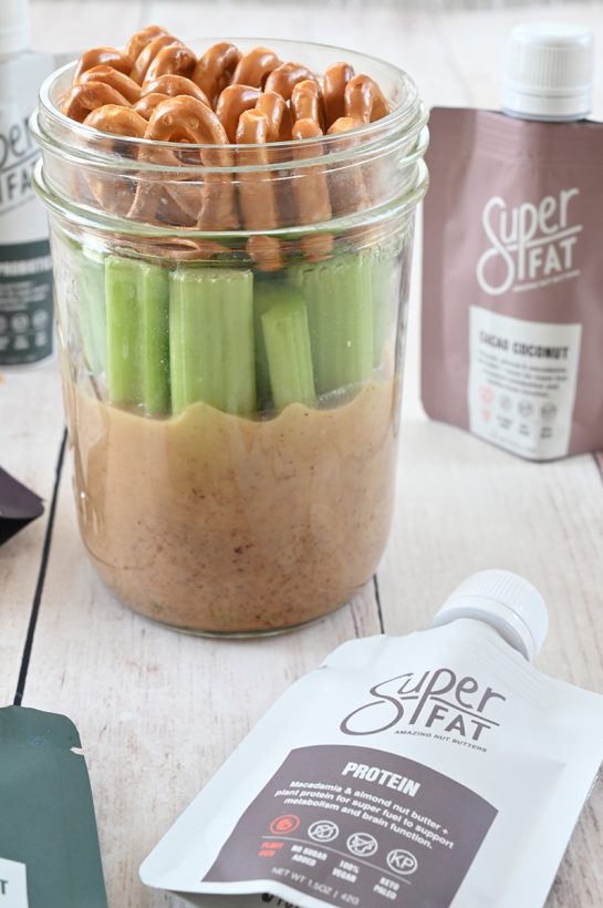 Mason Jar Pretzel, Celery, Almond Butter Snack with SuperFat nut butter is the perfect healthy on-the-go snack loaded with protein to give you a quick boost of energy during the day!