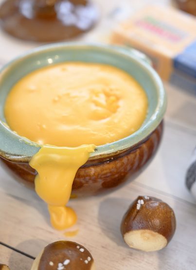 Cheddar Hard Cider Fondue recipe perfect for party appetizers or intimate dinners. Choose your favorite selection of dippers and see how delicious this is!