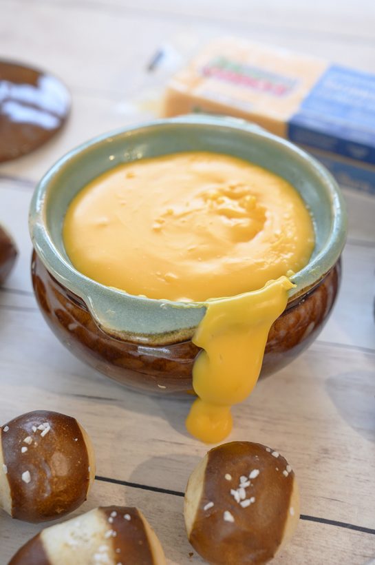 Cheddar Hard Cider Fondue recipe perfect for party appetizers or intimate dinners. Choose your favorite selection of dippers for football game day.