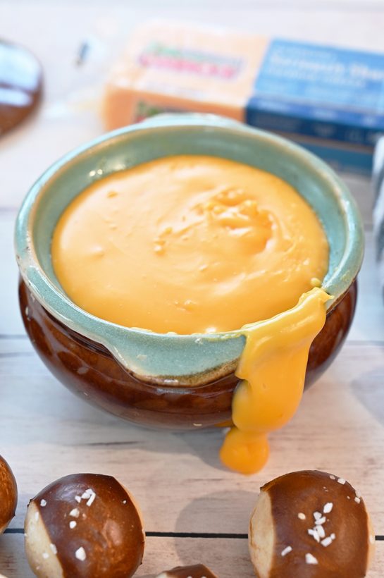 Easy Cheddar Hard Cider Fondue recipe perfect for party appetizers or intimate dinners. Choose your favorite selection of dippers for football game day.