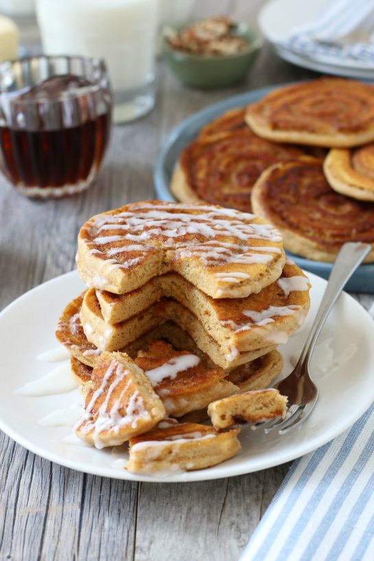 Triangle cut out of the stack of cinnamon swirl pancakes ready to be enjoyed.