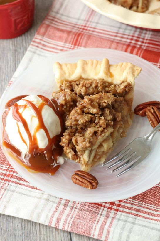 The caramel apple pie recipe is finished and plated up with some ice cream and caramel sauce.