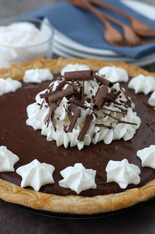 Close up of the finished old fashioned chocolate pie topped with chocolate and whipped cream.