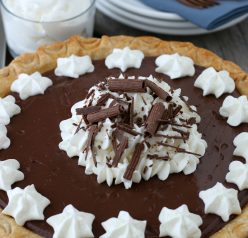 Finished homemade chocolate pudding pie topped with whipped cream and ready to be served.