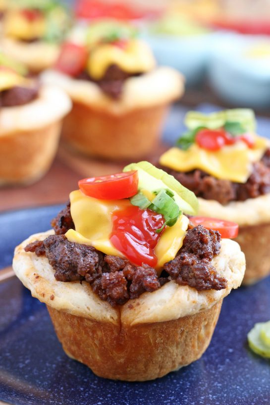 A close up shot of the finished cheeseburger biscuit bites with toppings ready to be eaten.