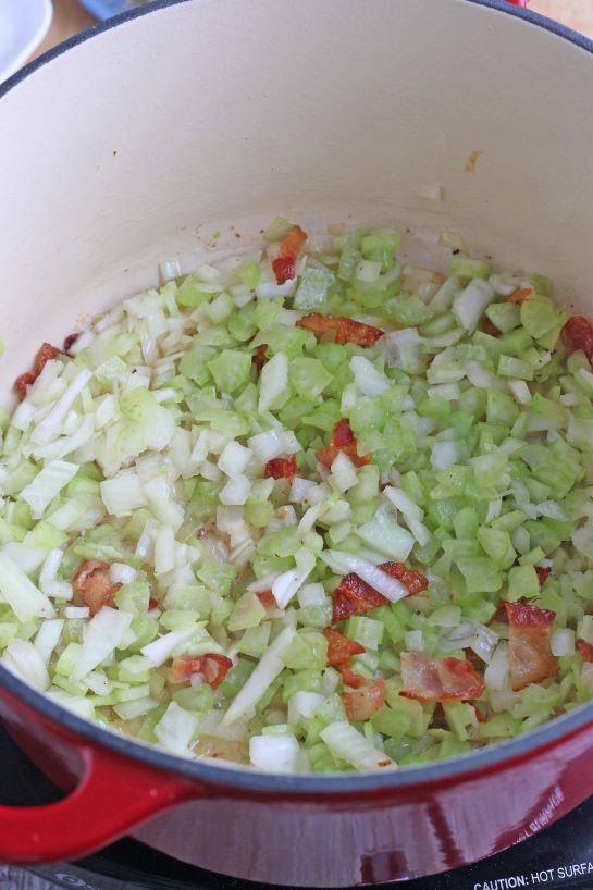 Now the vegetables, bacon, and seasonings are mixing within in pot as we make our New England clam chowder recipe.