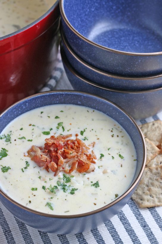 A bowl of soup with crispy bacon added on top ready to be enjoyed.