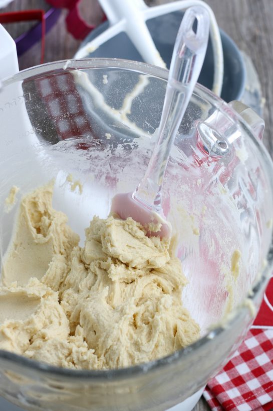 This image shows the batter for decorated sugar cookies in the stand mixer ready to be chilled and then rolled out.