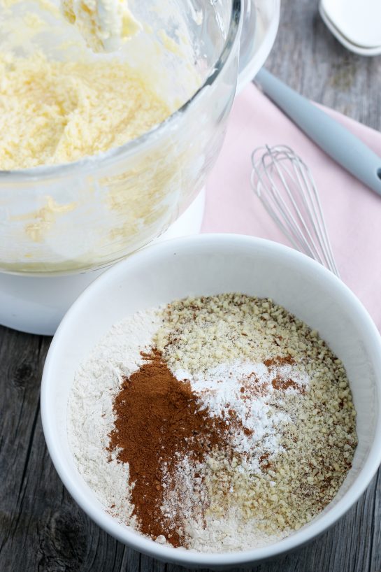 This image shows the dry ingredients being added into a bowl so they can be mixed up before they go into the stand mixer.