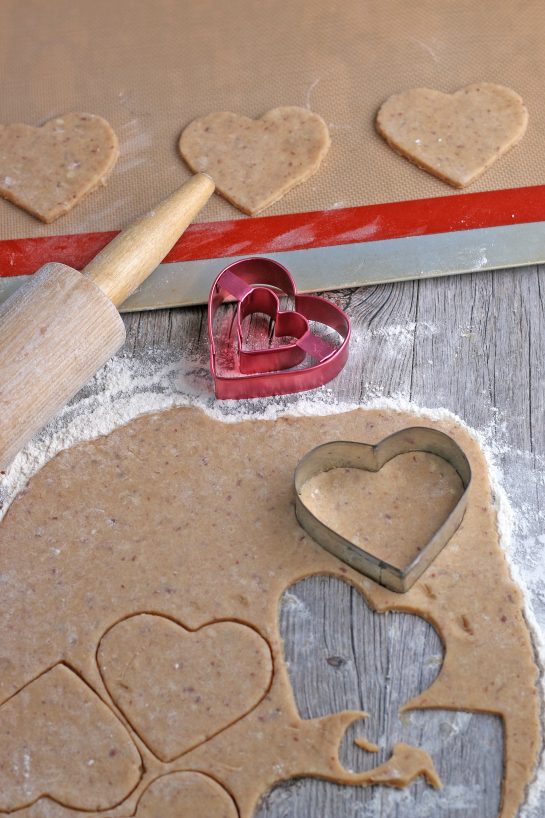 This image shows the heart shaped cookies being cut out and placed on our baking sheets.