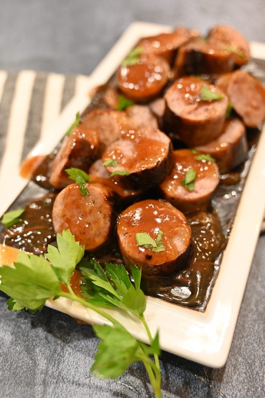 Grilled Beer Brat Bites appetizer recipe for any party simmered in a malty beer sauce with soft, nearly caramelized flavor that tastes delicious!