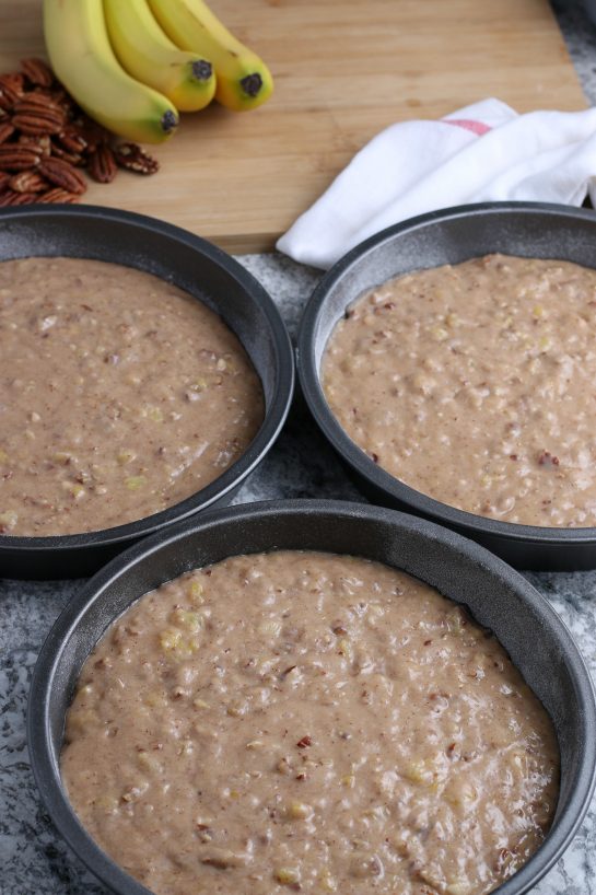 Pouring the cake batter into the cake pans for the Homemade Hummingbird Cake recipe