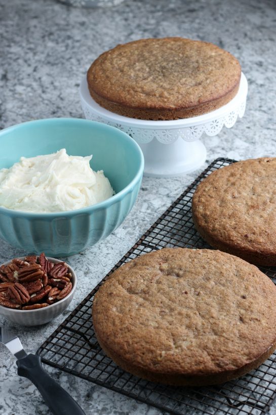 Taking the cake pans out of the oven for the Homemade Hummingbird Cake recipe