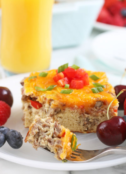 One serving of the breakfast egg casserole on a plate with a bite on a fork ready for eating!