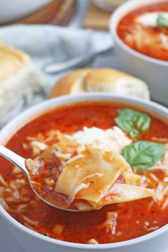 A spoonful of the delicious lasagna soup ready to be enjoyed.