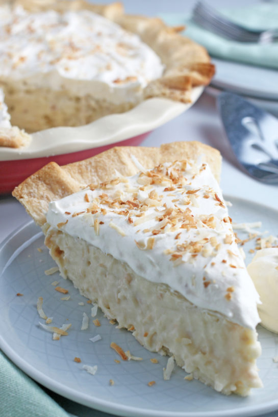 A close up shot of the finished pie, a slice of old fashioned coconut cream pie on a plate ready to eat.