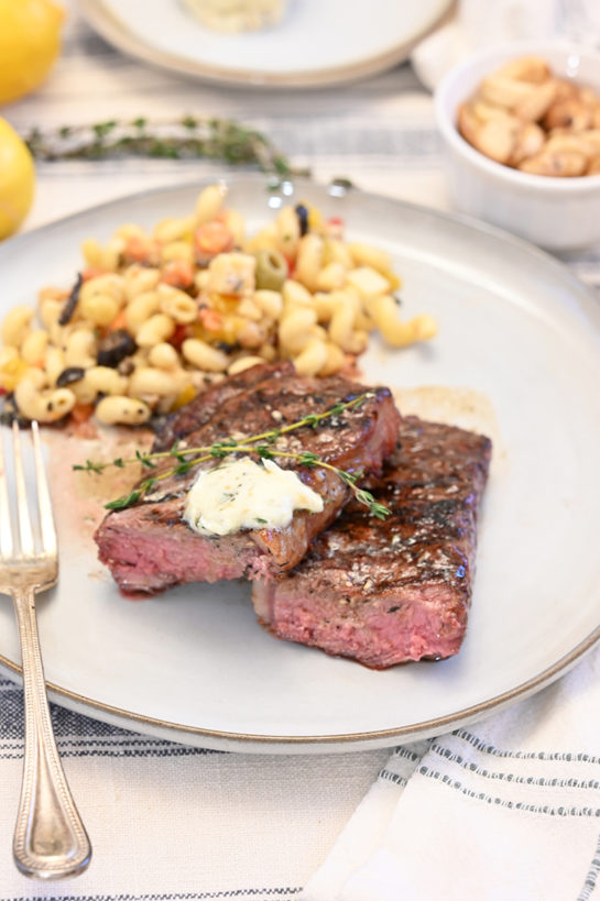 Perfect Grilled Strip Steaks with Herb Compound Butter is a gourmet dinner recipe at home! The compound butter is an easy and flavorful topping to add extra goodness to your steak!