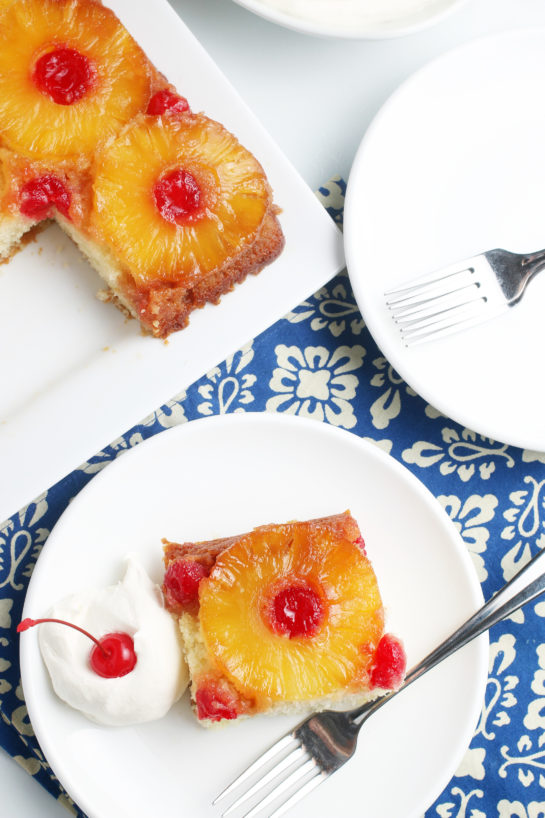 Another top down view of the finished recipe for pineapple upside down cake with a slice ready to be eaten.