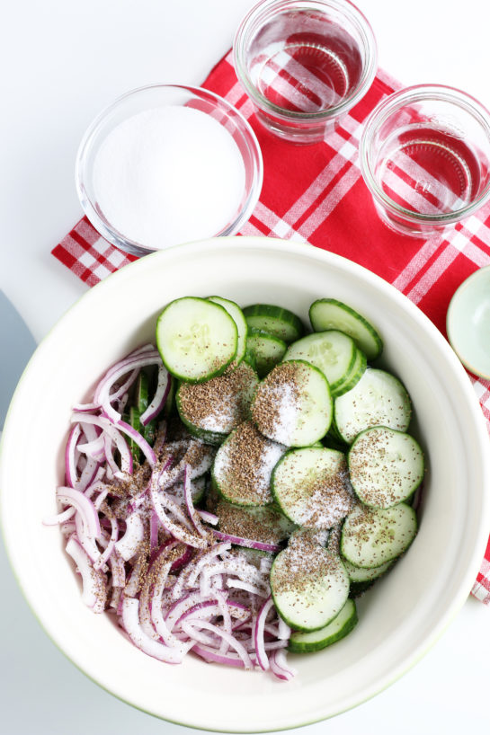 Adding the spices to the cucumber salad