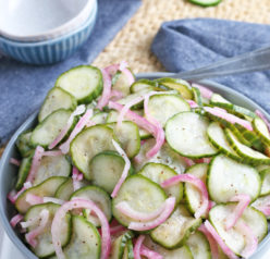Close-up photo of the finished cucumber salad recipe served in a large serving bowl for a picnic