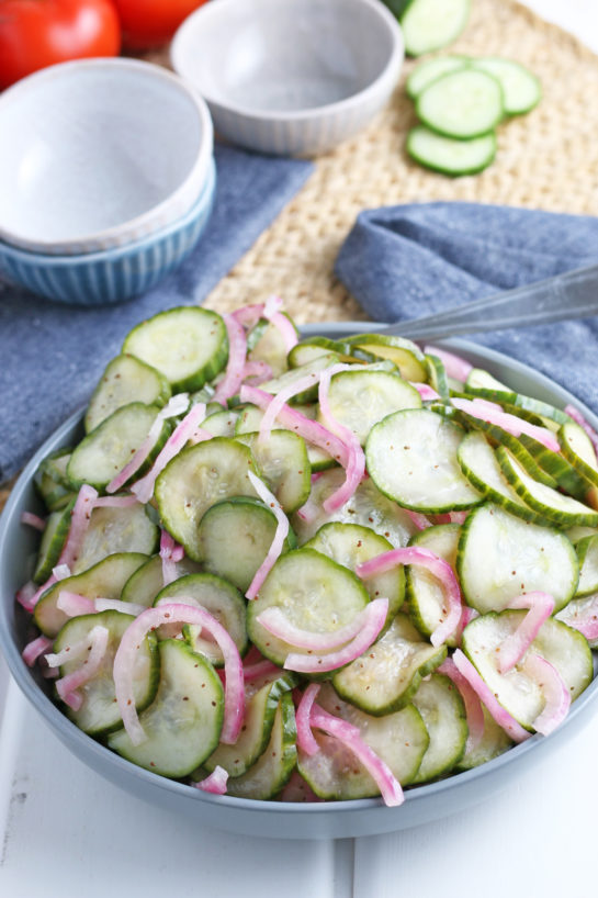 Close-up photo of the finished cucumber salad recipe served in a large serving bowl for a picnic
