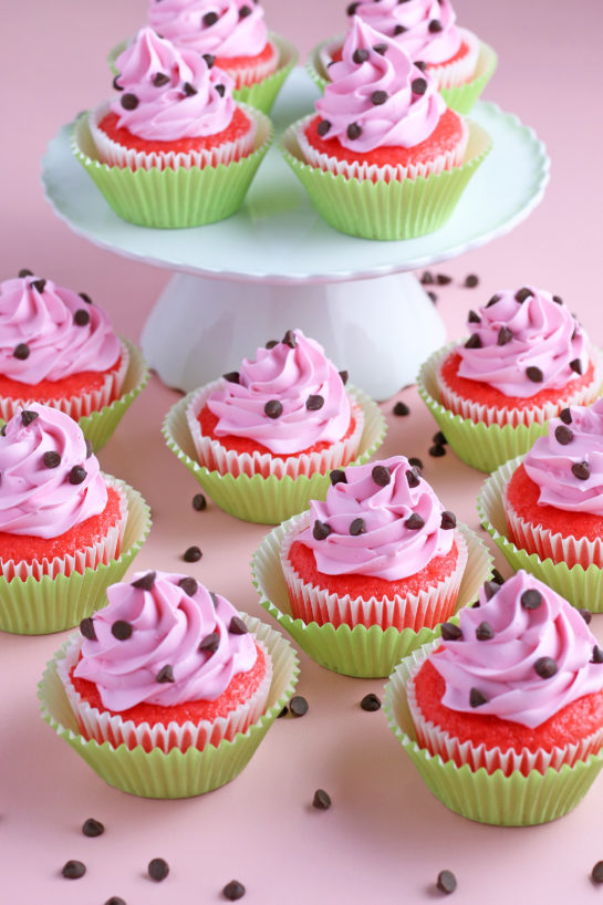 Watermelon Cupcakes topped with homemade buttercream! These fluffy vanilla cupcakes are bursting with juicy pockets of watermelon and the hot pink frosting is so pretty and delicious. These are the perfect summer cupcake recipe!