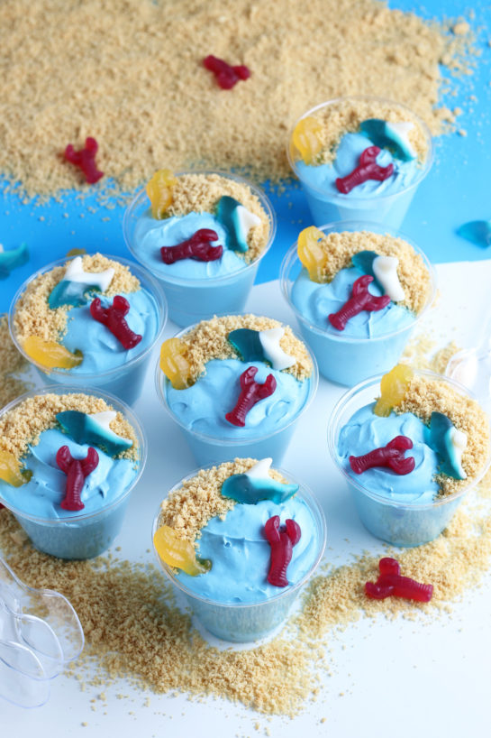 Beach Sand Pudding Cups are an adorable and oh-so-delicious no-bake dessert recipe for kids!  Made with vanilla pudding, food coloring, and whipped topping they are the cutest snack for a party or snack!