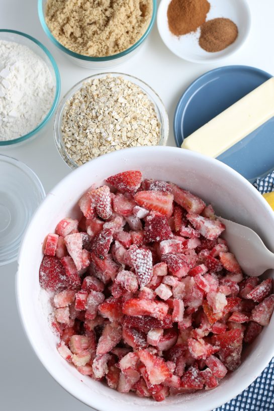 Mixing the dry ingredients with wet ingredients for Strawberry & Rhubarb crisp recipe