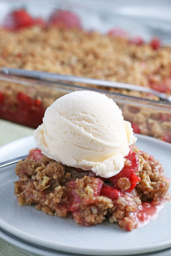 Strawberry & Rhubarb crisp recipe finished in the pan and out of the oven and plated with ice cream on top