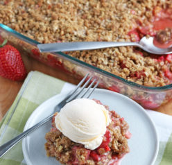 Strawberry Rhubarb crisp recipe finished in the pan and out of the oven and plated with a scoop of vanilla ice cream on top