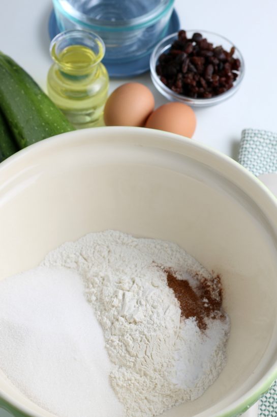 Mixing the dry ingredients with cinnamon needed to make the zucchini muffins recipe