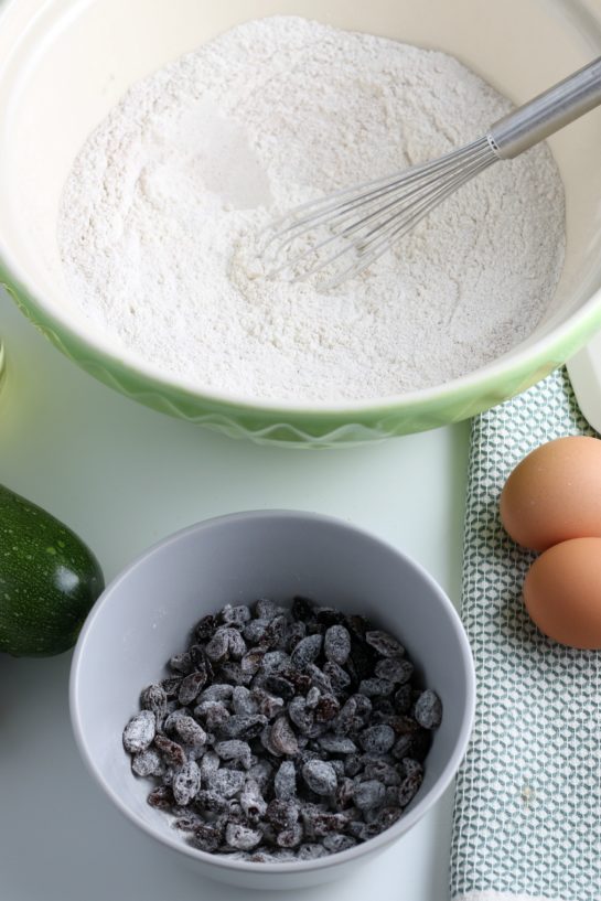 Adding the raisins to make the zucchini muffins recipe