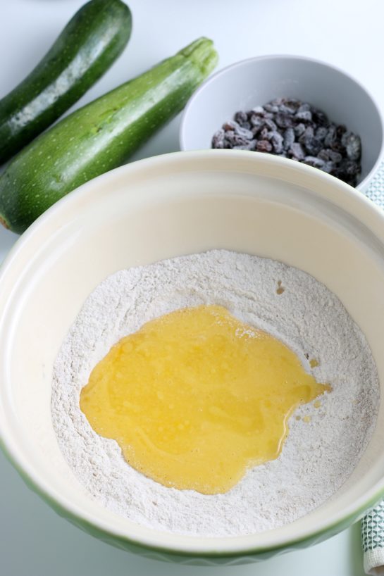 Adding the eggs to the dry ingredients to make the zucchini muffins