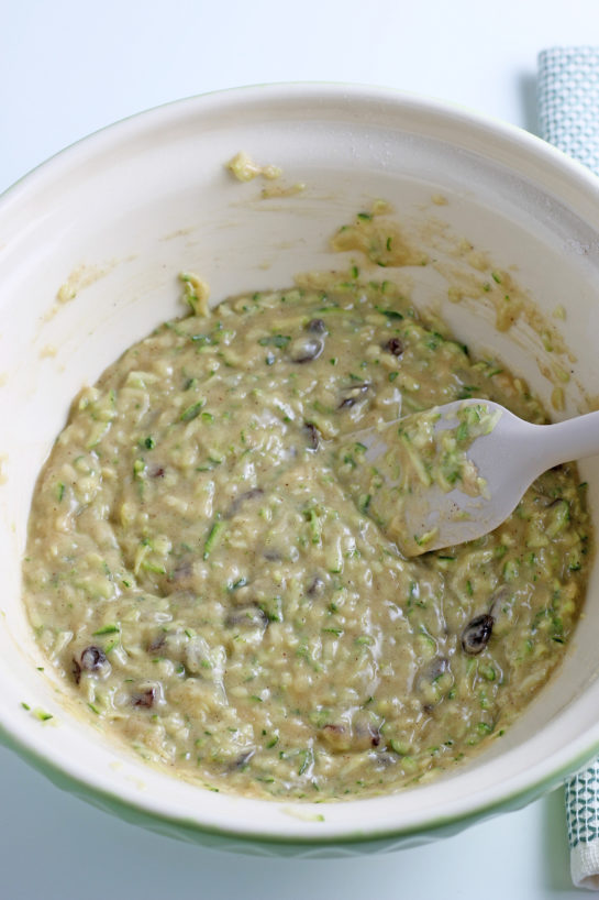 Mixing together the wet ingredients with the dry ingredients to make the zucchini muffins recipe