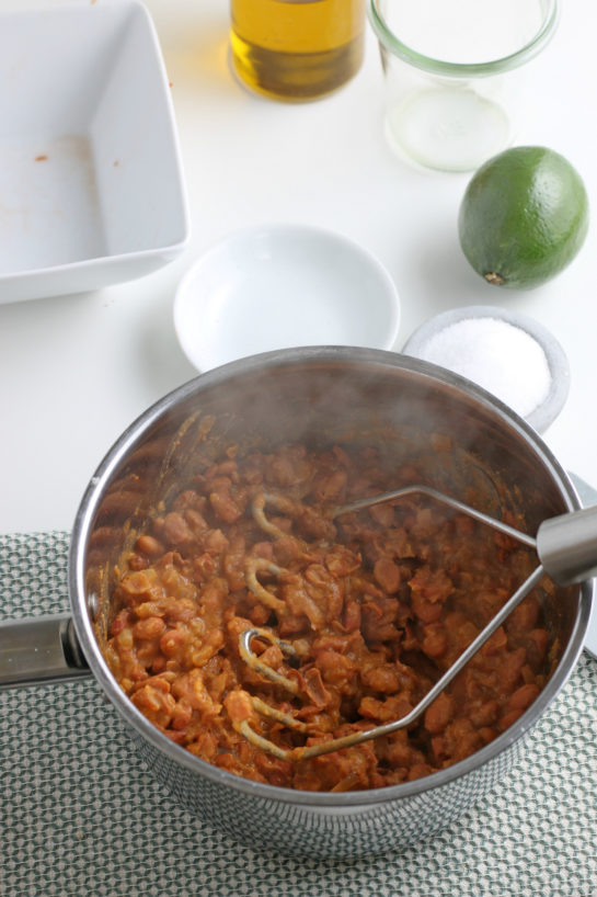 Mashing the beans for the homemade refried beans