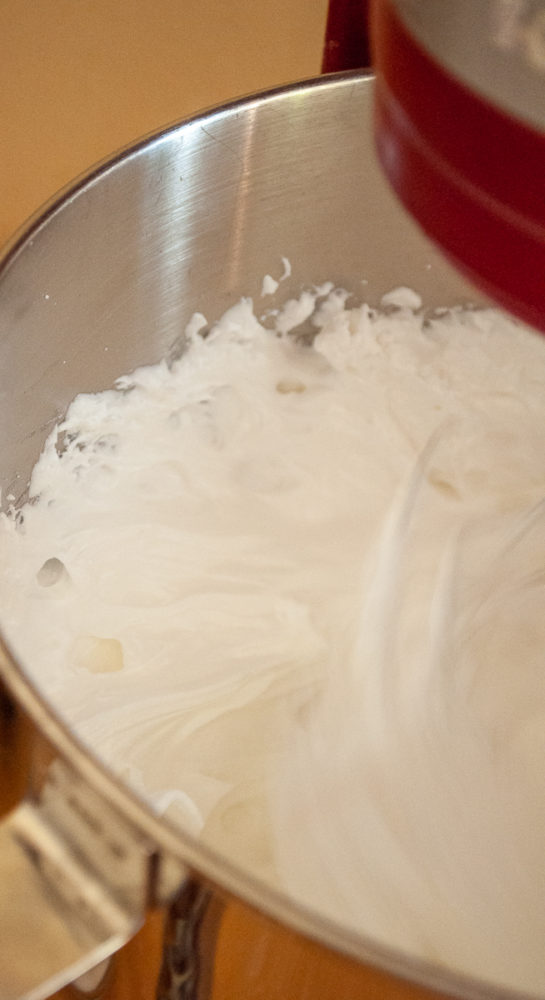 Whipping the egg whites for the meringue to make the Halloween Boo Meringues