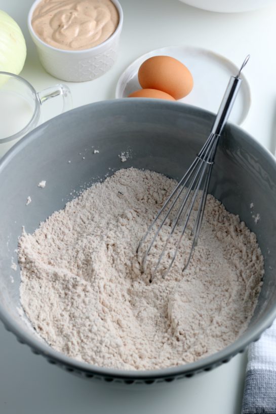 Mixing the dry ingredients and spices needed to make fried blooming onion recipe