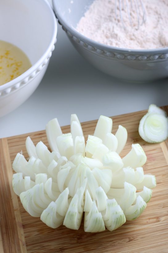Slicing up the onion and making it "bloom" like a flower for the blooming onion recipe