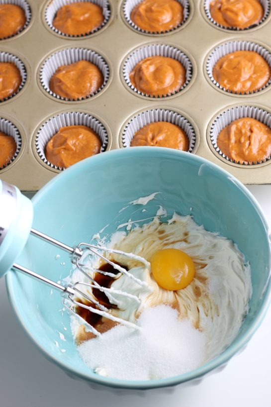 Mixing the eggs with all of the ingredients for the Simple Pumpkin Cream Cheese Muffins
