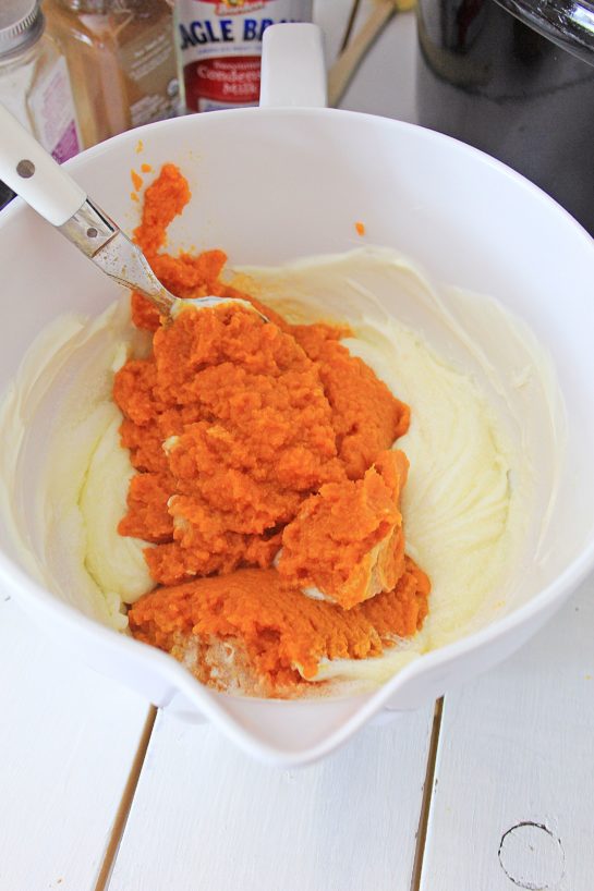 Adding the pumpkin puree for the crock pot pumpkin bread pudding