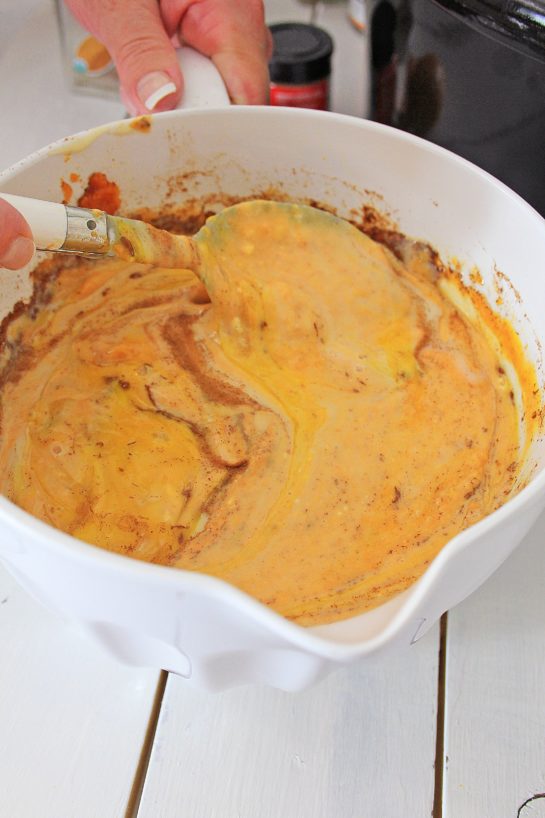 Mixing the wet ingredients for the crock pot pumpkin bread pudding