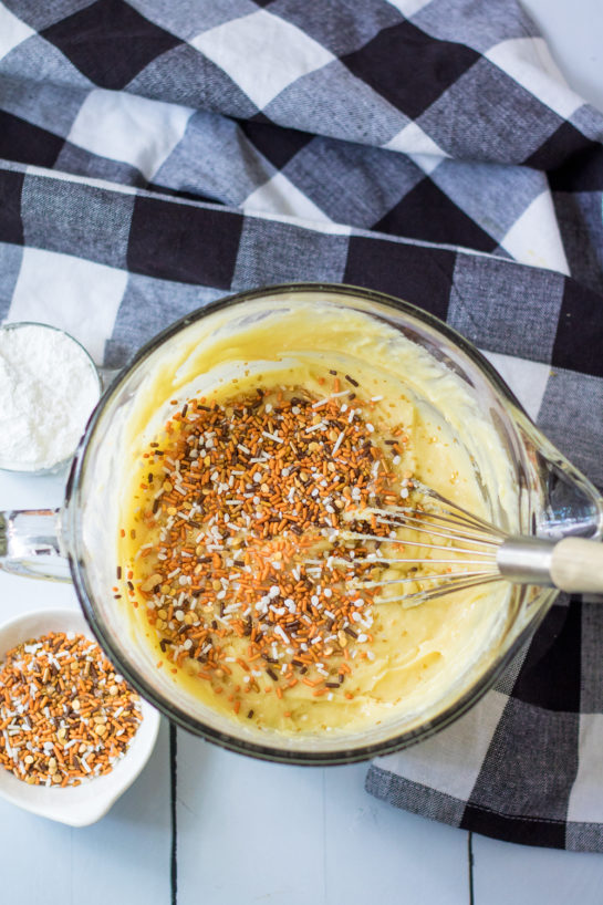 Adding the sprinkles to the batter for the Fall Confetti Sweet Bread recipe 