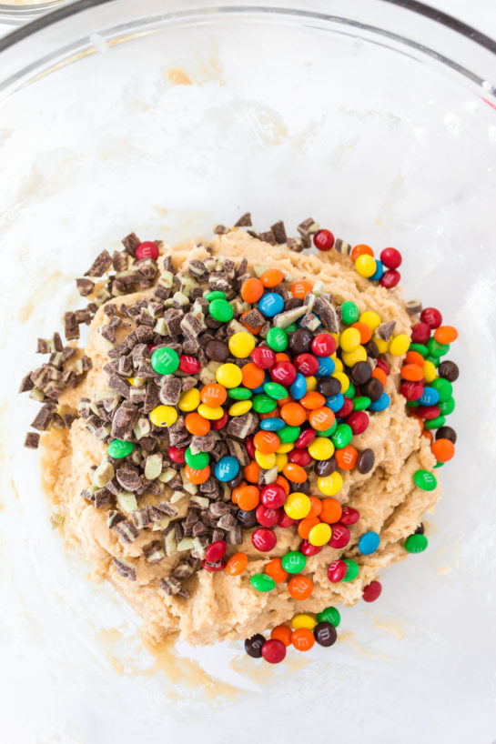 Adding the candy needed for Edible Cookie Dough Bombs recipe