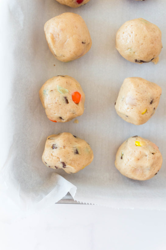 Close up of the dough balls being added to the baking tray for Edible Cookie Dough Bombs recipe