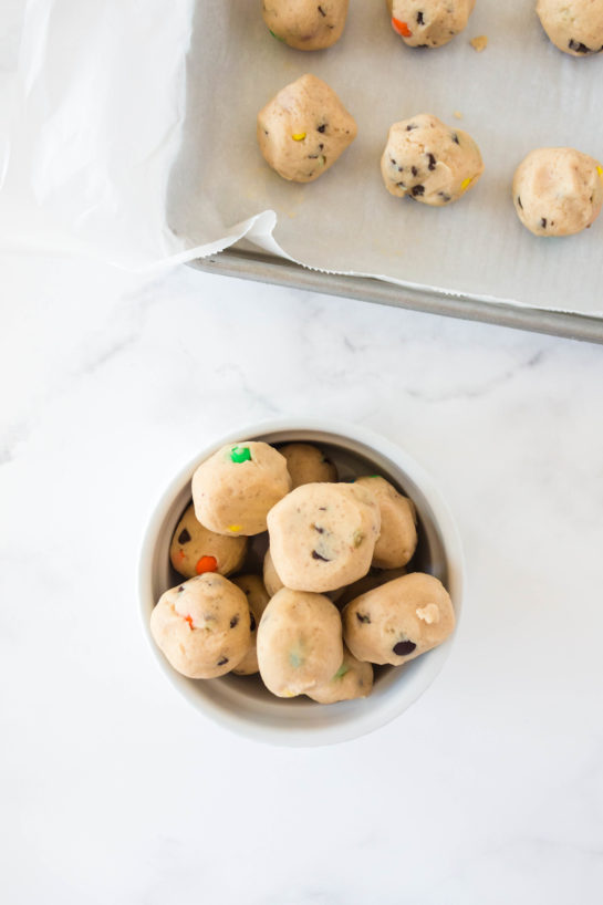 The dough balls reading to be dipped in the white chocolate for Edible Cookie Dough Bombs recipe