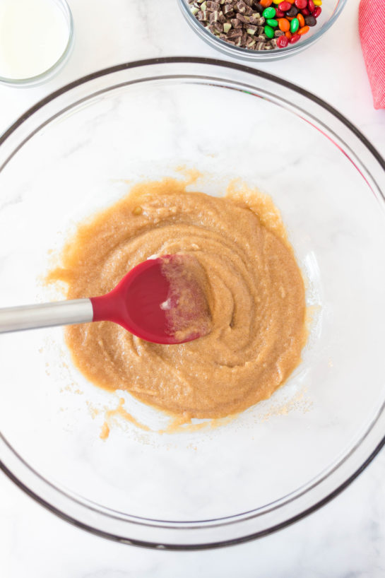 Adding the wet ingredients to the dry ingredients needed for Edible Cookie Dough Bombs recipe