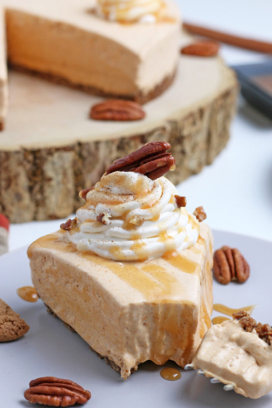 Close-up shot of the No Bake Pumpkin Cheesecake with extra spiced flavor and gingersnap crust. It is a fool proof recipe because it turns out amazing every time! This is the perfect holiday dessert!