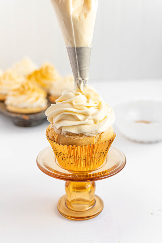 Piping the frosting for the Champagne Cupcakes recipe