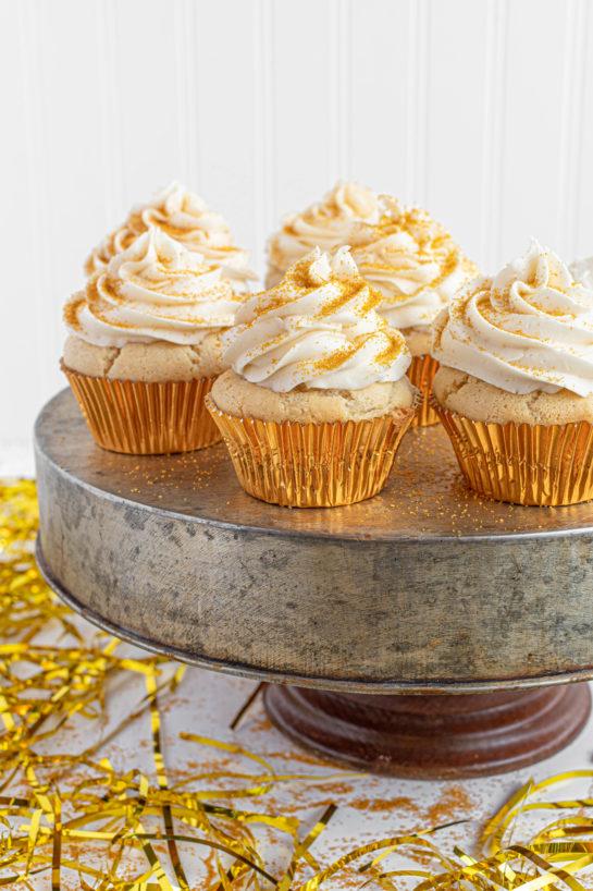 Celebration Champagne Cupcakes recipe is perfect for birthdays, Mother's Day brunch or a New Year’s Eve dessert! They are jazzed up with gold sprinkles to add some glam!