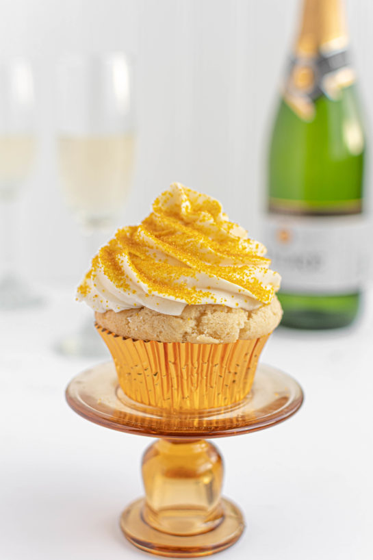 New Year's Eve Champagne Cupcakes recipe is perfect for birthdays, Mother's Day brunch or a New Year’s Eve dessert! They are jazzed up with gold sprinkles to add some glam!